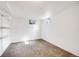 Unfinished basement with carpeted floors, shelving and natural light at 7350 Dale Ct, Westminster, CO 80030