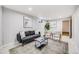 Comfortable basement living area with stylish seating, contemporary art, and ample natural light at 7350 Dale Ct, Westminster, CO 80030