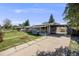 Charming single-story home with a covered front porch, driveway, and solar panels at 7350 Dale Ct, Westminster, CO 80030
