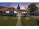 Charming single-story home with solar panels and well-maintained front yard at dusk at 7350 Dale Ct, Westminster, CO 80030