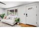 Bright living room features a large window, comfortable couch, and hardwood floors at 7350 Dale Ct, Westminster, CO 80030