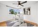 Bright office space with large windows, ceiling fan, and modern decor, creating an ideal workspace at 7350 Dale Ct, Westminster, CO 80030