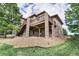 Spacious stone-clad back deck offering an outdoor entertainment space with yard views at 12161 S Leaning Pine Ct, Parker, CO 80134