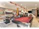 Basement game room featuring a pool table, ping pong table and wet bar at 12161 S Leaning Pine Ct, Parker, CO 80134