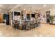 Basement bar area featuring stone accents, pendant lighting, and seating at 12161 S Leaning Pine Ct, Parker, CO 80134