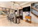 Basement bar area with stone accents, tile flooring, and large screen television at 12161 S Leaning Pine Ct, Parker, CO 80134