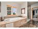 Luxurious bathroom features a soaking tub, walk-in shower, and a spacious walk-in closet at 12161 S Leaning Pine Ct, Parker, CO 80134