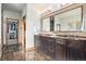 Luxurious bathroom with double vanity, marble counters, and a walk-in closet at 12161 S Leaning Pine Ct, Parker, CO 80134