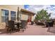 Spacious deck features comfortable seating, dining table, and a red entry door at 12161 S Leaning Pine Ct, Parker, CO 80134