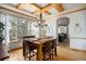 Dining area with a wooden table, modern chandelier, and access to the outdoor space at 12161 S Leaning Pine Ct, Parker, CO 80134
