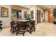 Cozy dining area with a poker table, large windows, and travertine flooring at 12161 S Leaning Pine Ct, Parker, CO 80134