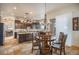 Dining area with a wooden table, modern chandelier, and access to the outdoor space at 12161 S Leaning Pine Ct, Parker, CO 80134