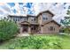 Inviting home featuring stone accents, a well-manicured lawn, and lush greenery at 12161 S Leaning Pine Ct, Parker, CO 80134