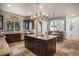 Gourmet kitchen with stainless steel appliances, granite countertops, and custom cabinetry at 12161 S Leaning Pine Ct, Parker, CO 80134