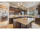 Gourmet kitchen with stainless steel appliances, granite countertops, and custom cabinetry at 12161 S Leaning Pine Ct, Parker, CO 80134