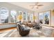 Inviting living room with arched windows offering stunning views, complemented by cozy seating and decor at 12161 S Leaning Pine Ct, Parker, CO 80134