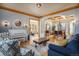 Open living room with hardwood floors and coffered ceilings leading to the dining area at 12161 S Leaning Pine Ct, Parker, CO 80134