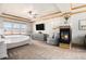 Relaxing main bedroom with modern fireplace, ceiling fan, and neighborhood views at 12161 S Leaning Pine Ct, Parker, CO 80134