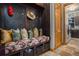 Functional mudroom featuring a bench, storage cubbies, and access to the laundry room at 12161 S Leaning Pine Ct, Parker, CO 80134