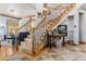 Elegant staircase with wooden rails, iron spindles, and tiled flooring at 12161 S Leaning Pine Ct, Parker, CO 80134