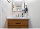 Bathroom featuring white countertops, wood cabinets, and modern fixtures at 2557 S Dover St # 30, Lakewood, CO 80227
