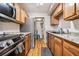 Well-maintained kitchen with granite countertops, modern appliances, and wood cabinets at 2557 S Dover St # 30, Lakewood, CO 80227