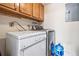 Efficient laundry room featuring washer, dryer, and storage cabinets at 2557 S Dover St # 30, Lakewood, CO 80227