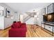 Cozy living room with hardwood floors, red sofa, staircase and modern decor at 2557 S Dover St # 30, Lakewood, CO 80227