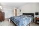 Spacious bedroom with a large bed, closet, and ensuite entrance at 2557 S Dover St # 30, Lakewood, CO 80227