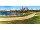 Walk along a paved walking path next to a pond in the greenbelt surrounded by mature trees at 2557 S Dover St # 30, Lakewood, CO 80227