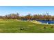Picturesque view of lake and trees along paved walkway with greenbelt, perfect for bird watching at 2557 S Dover St # 30, Lakewood, CO 80227