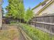 Backyard featuring a charming fence, garden, and mature trees for ultimate privacy at 4267 Ashcroft Ave, Castle Rock, CO 80104