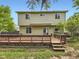 Green backyard featuring a spacious wooden deck, a mature tree, and a well maintained lawn at 4267 Ashcroft Ave, Castle Rock, CO 80104
