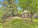 Landscaped backyard featuring a spacious wooden deck, mature trees, and a well maintained lawn at 4267 Ashcroft Ave, Castle Rock, CO 80104