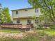 Green backyard featuring a spacious wooden deck, a mature tree, and a well maintained lawn at 4267 Ashcroft Ave, Castle Rock, CO 80104