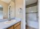 Bathroom vanity with a sink, mirror, and doorway view of a tiled shower-over-tub combo at 4267 Ashcroft Ave, Castle Rock, CO 80104