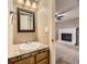 Charming bathroom featuring a decorative mirror and classic tile work, with a glimpse into the living room at 4267 Ashcroft Ave, Castle Rock, CO 80104