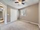 Neutral bedroom with a ceiling fan, closet, window, and carpeted floors at 4267 Ashcroft Ave, Castle Rock, CO 80104