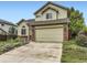 Charming two-story home with a well-maintained lawn, garden beds, and an attached two-car garage at 4267 Ashcroft Ave, Castle Rock, CO 80104