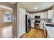 Well-equipped kitchen featuring white cabinets, stainless steel appliances, and hardwood floors at 4267 Ashcroft Ave, Castle Rock, CO 80104