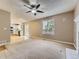 Open-concept living room with a fireplace, kitchen view, and a ceiling fan at 4267 Ashcroft Ave, Castle Rock, CO 80104