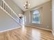 Bright living room with hardwood floors, large windows, and a staircase at 4267 Ashcroft Ave, Castle Rock, CO 80104