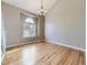 Sunlit living room featuring hardwood floors, a chandelier, and a large window at 4267 Ashcroft Ave, Castle Rock, CO 80104