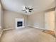 Spacious living room with a classic white fireplace, a ceiling fan, and a bright front door entrance at 4267 Ashcroft Ave, Castle Rock, CO 80104
