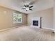 Inviting living room featuring a cozy fireplace, ceiling fan, and a large window for natural light at 4267 Ashcroft Ave, Castle Rock, CO 80104