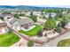 Aerial view of a home showcasing a lush backyard with a patio, firepit, and landscaping at 15635 Dawson Creek Dr, Monument, CO 80132
