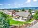 Aerial view of a home with a private backyard, lush landscaping, pergola, and mountain views at 15635 Dawson Creek Dr, Monument, CO 80132