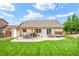 A spacious backyard boasts a pergola-covered patio, lush lawn, and convenient storage shed at 15635 Dawson Creek Dr, Monument, CO 80132