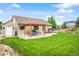 Lovely backyard featuring a patio with pergola, a storage shed, and mature landscaping at 15635 Dawson Creek Dr, Monument, CO 80132