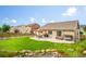 View of the backyard features a patio with pergola, lush lawn, and tasteful landscaping at 15635 Dawson Creek Dr, Monument, CO 80132
